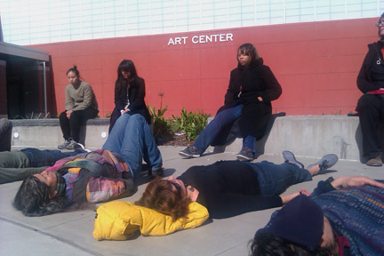 WEFT Laney College: people lying down, experiencing the materiality of their clothes